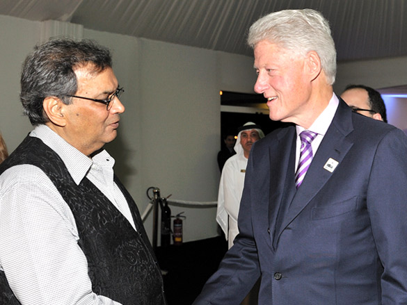ghai greets bill clinton in dubai at the promotion of education worldwide 3