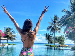 HOT: Disha Patani poses in a floral swimsuit against a serene backdrop