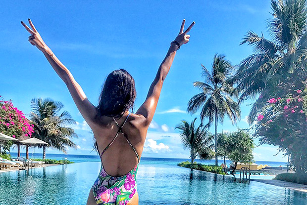 HOT Disha Patani poses in a floral swimsuit against a serene backdrop
