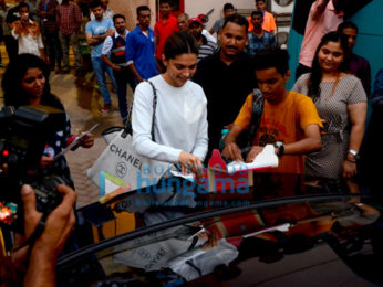 Deepika Padukone cuts a cake for a fan