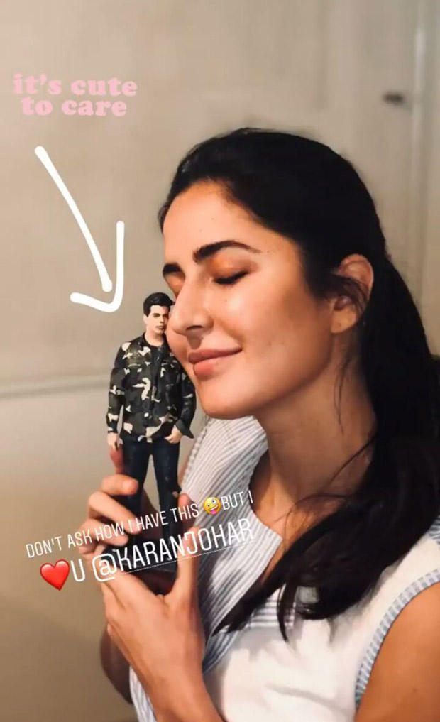 Katrina Kaif poses with a miniature doll of Karan Johar 