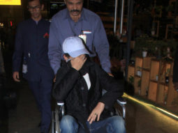 A wheelchair-bound Irrfan Khan hides his face as the paparazzi spots him at the airport