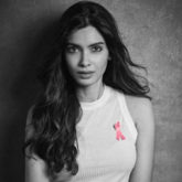 Estée Lauder's global brand ambassador, Diana Penty, dons a pink ribbon for breast cancer awareness