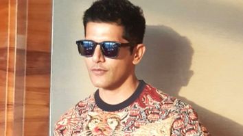 Karanvir Bohra cleans litter at the airport before boarding the flight