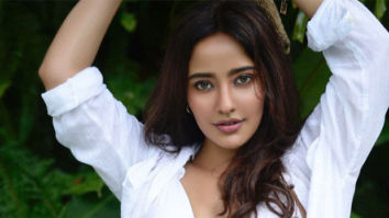 Neha Sharma looks stunning as she pairs her white bikini with an oversized shirt
