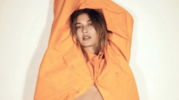 Hailey Bieber poses sensually in orange Balenciaga sweatsuit for Vogue Brasil
