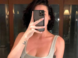 Mandana Karimi shares a message about self love as she poses in a grey and pink bikini