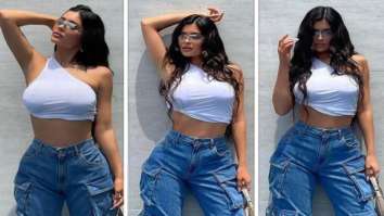 Kylie Jenner channels 90s and Y2K vibes in one-shoulder white crop top and baggy wide-leg jeans