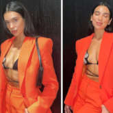 Dua Lipa makes a strong case for neon orange pantsuit paired with floss string bikini top