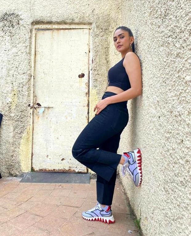 For Toofan promotions, Mrunal Thakur pairs crop top and flared denims with Christian Louboutin sneakers worth Rs. 62,795