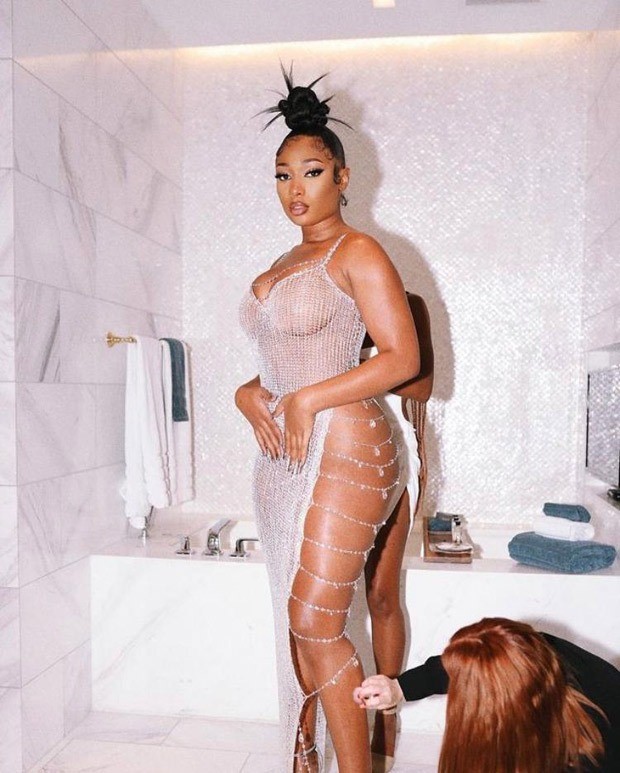 Megan Thee Stallion sets the internet ablaze in sheer crystal chain dress with waist-high slit for Sports Illustrated swimsuit launch