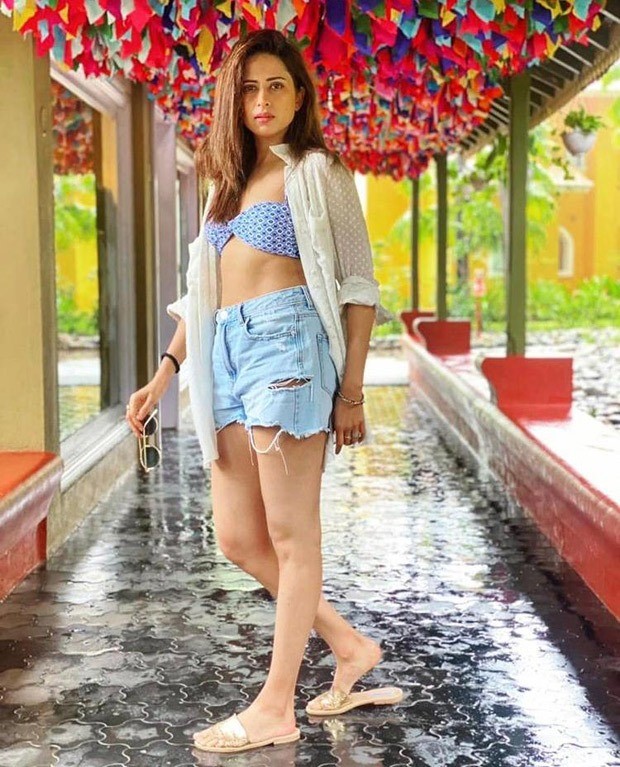 Sargun Mehta's off-duty look consists of a printed bralette, high waisted denim shorts & white shirt