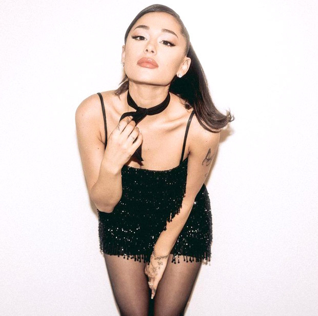 Ariana Grande stuns in a mini black dress with glitter details, stockings and signature high pony tail Ariana Grande stuns in a mini black dress with glitter details, stockings and signature high pony tail