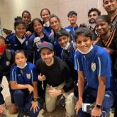 Varun Dhawan poses with the Indian Women's Football team at the airport