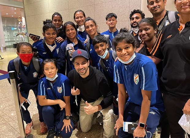Varun Dhawan poses with the Indian Women's Football team at the airport
