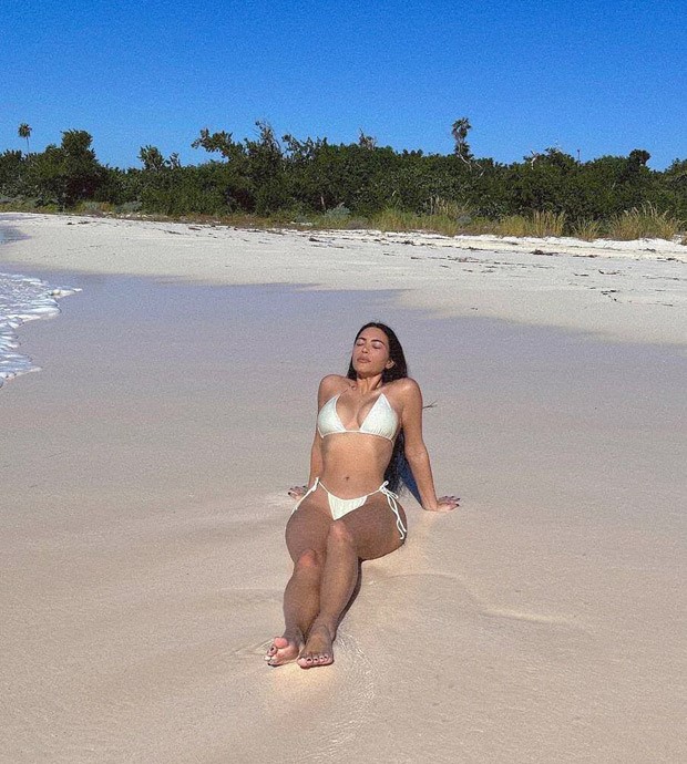 Kim Kardashian flaunts her curves in sultry white bikini; fans are convinced the latest Bahamas photos are taken by Pete Davidson