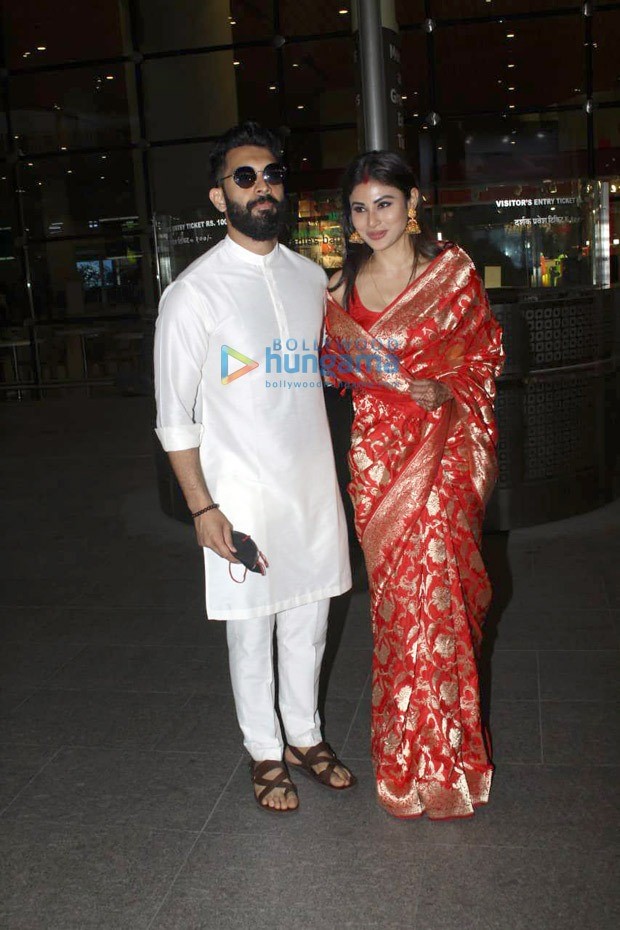 Newlywed Mouni Roy glows in red Banarasi saree with husband Suraj Nambiar as they make first appearance at airport in Mumbai