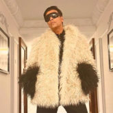 Karan Johar strikes a pose in a Gucci outfit paired with red boots; Farah Khan calls it Ostrich outfit, netizens agree