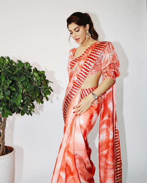 Jacqueline Fernandez looks elegant during Bachchhan Paandey promotions in breathtaking orange printed contemporary saree and backless blouse
