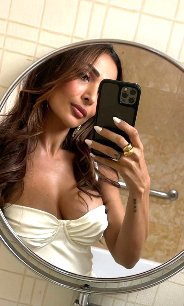 Malaika Arora is vision in pearl white strappy corset style thigh-high slit dress