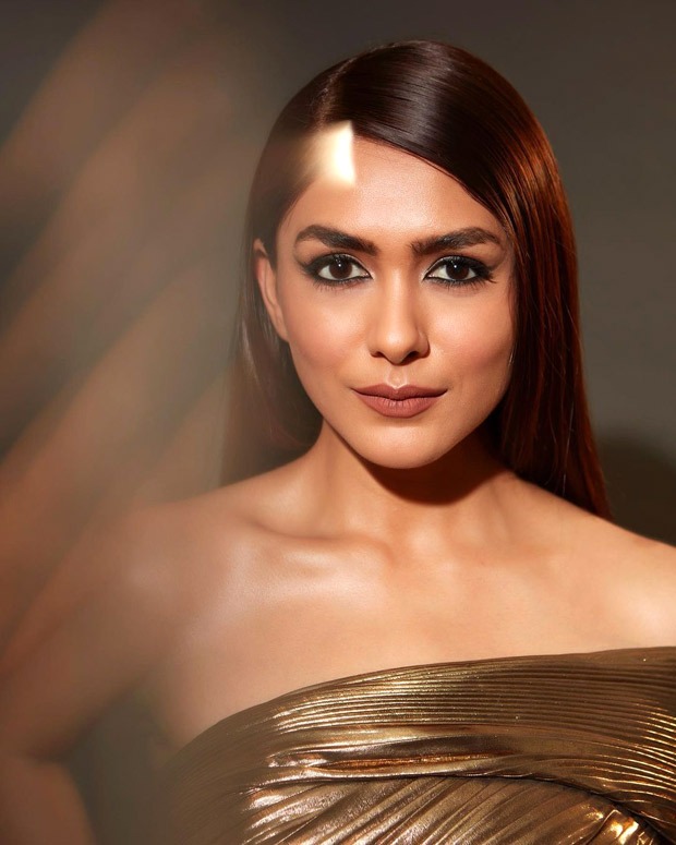 Mrunal Thakur exudes glamorous eminence in one-shoulder thigh-high slit gold metallic gown and fierce eyes 