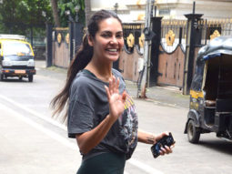 Esha Gupta waves as she poses for paps