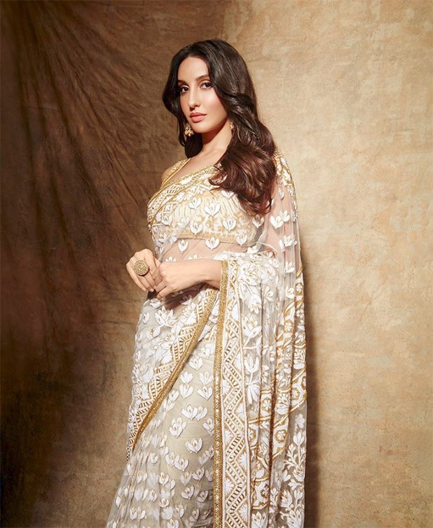 Nora Fatehi is a sight to behold in Manish Malhotra’s sheer floral ivory saree and sleeveless blouse