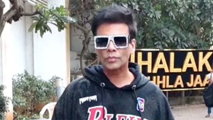 Karan Johar poses for paps in a hoodie and funky glasses