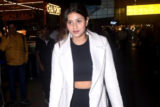 Anjali Arora gets clicked at the airport sporting a white overcoat