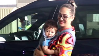 Hazel Keech poses with her cute little baby at the airport