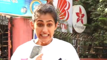 Kubbra Sait cheerfully waves at paps outside gym