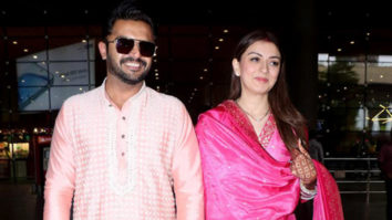 Newly wed Hansika Motwani walks hand in hand with her husband at the airport