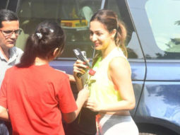 Malaika Arora receives a rose from a fan as she gets clicked outside gym