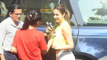 Malaika Arora receives a rose from a fan as she gets clicked outside gym