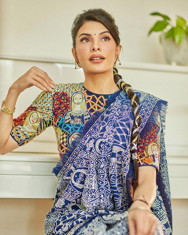 Youll appear like the most stylish wedding guest around in this blue abstract saree by Abu Jani Sandeep Khosla worn by Jacqueline Fernandez 2