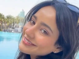 Neha Sharma has a wide smile spread across her face as she enjoys her pool time
