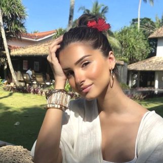 Tara Sutaria is the chicest beach beauty as she basks in the sun sporting a breezy white outfit and a red flower in her hair