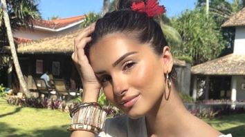 Tara Sutaria is the chicest beach beauty as she basks in the sun sporting a breezy white outfit and a red flower in her hair