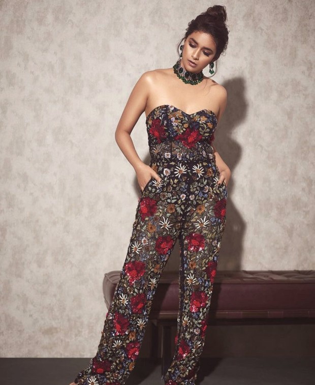 Keerthy Suresh exudes spring charm in a gorgeous flowery black strapless jumpsuit by Varun Bahl, which costs Rs.2 Lakh