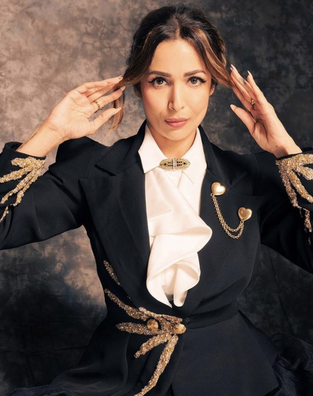 Malaika Arora is one of the most stylish ballerinas we have ever seen, wearing a fitted gold embroidered jacket with a flared skirt with pleats 