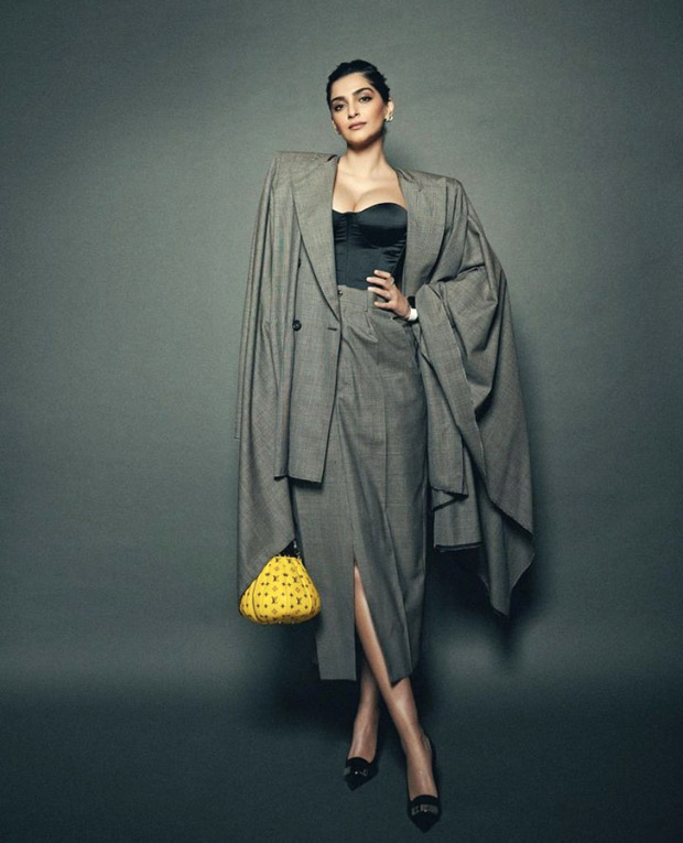 Sonam Kapoor bewitches in a grey skirt suit and corset with a pop of colour with yellow Louis Vuitton bag