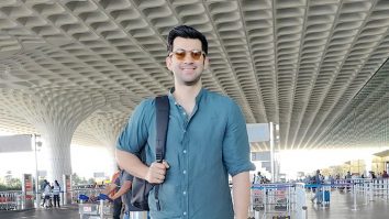 Karan Deol opts for a blue shirt as he poses for paps at the airport