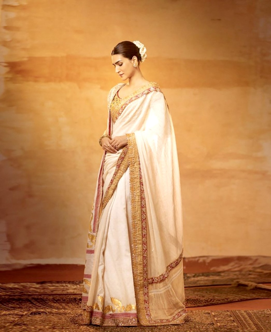 Kriti Sanon graces the Adipurush trailer launch in a captivating gold saree, inspired by the purity of Sita, beautifully crafted by Abu Jani Sandeep Khosla