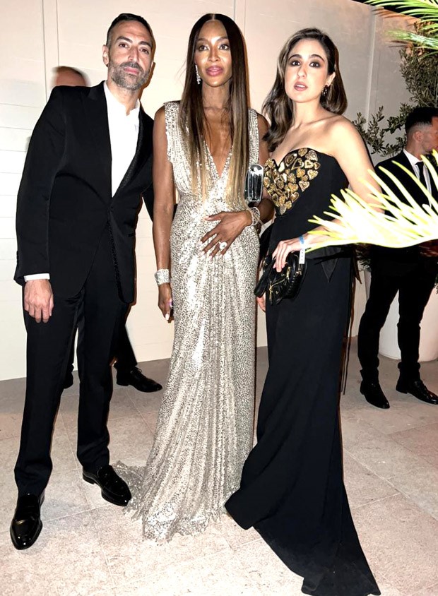 Sara Ali Khan smiles for the camera in a heart-pattern Moschino dress and heart-shaped purse with Naomi Campbell at Cannes 2023