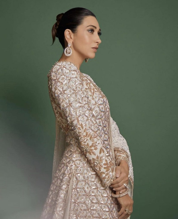 Karisma Kapoor is a vision of ethereal beauty in a white Manish Malhotra lehenga, adorned with a long jacket