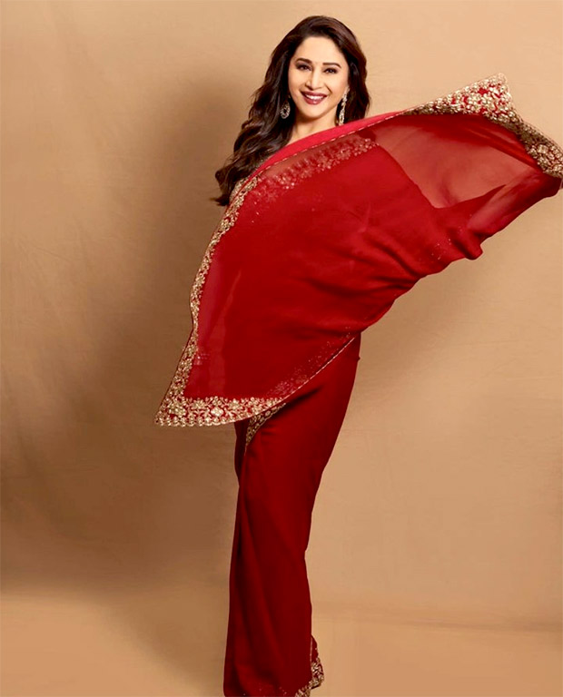 Madhuri Dixit is a picture of elegance in red and gold saree by Arpita Mehta