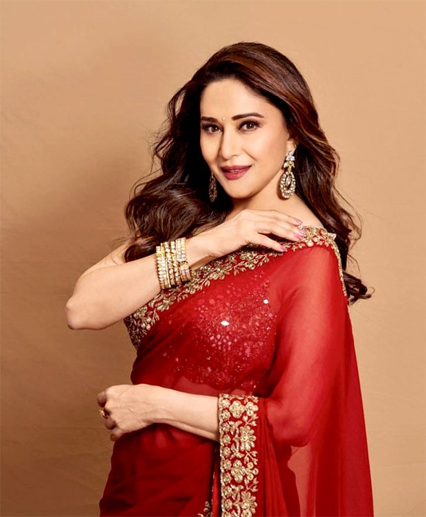 Madhuri Dixit is a picture of elegance in red and gold saree by Arpita Mehta