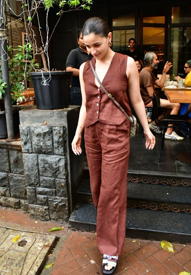 Alia Bhatt perfects the relaxed elegant look with casual brown pants and a waistcoat, together with a Gucci bag costing Rs.  1.35 lakhs