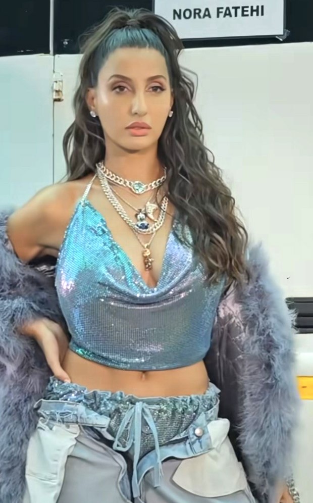 Nora Fatehi in a shiny chainmail top and inside out denim jeans is ...