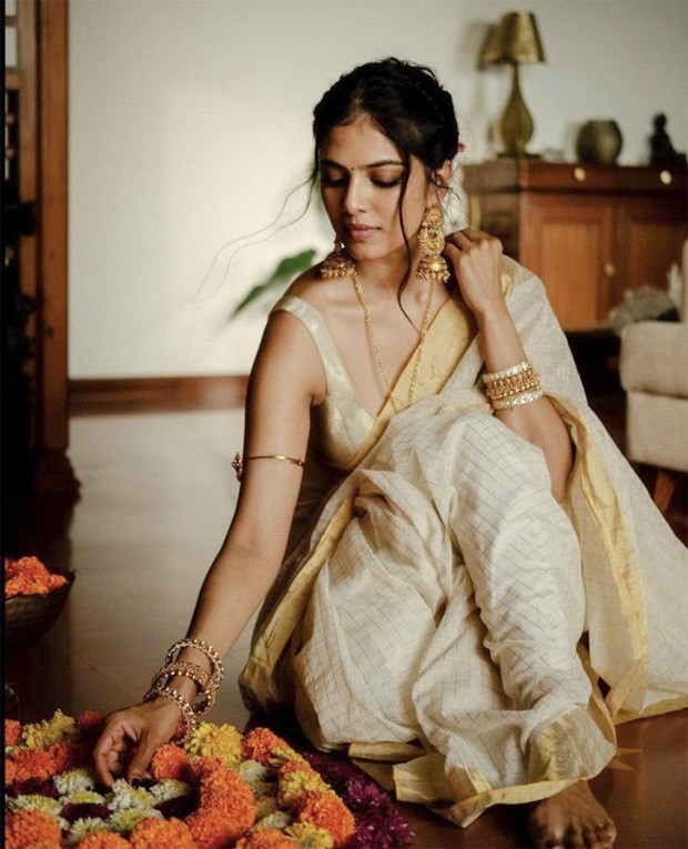 Malavika Mohanan weaves a picture of pure elegance on the occasion of Onam in an ivory and gold saree